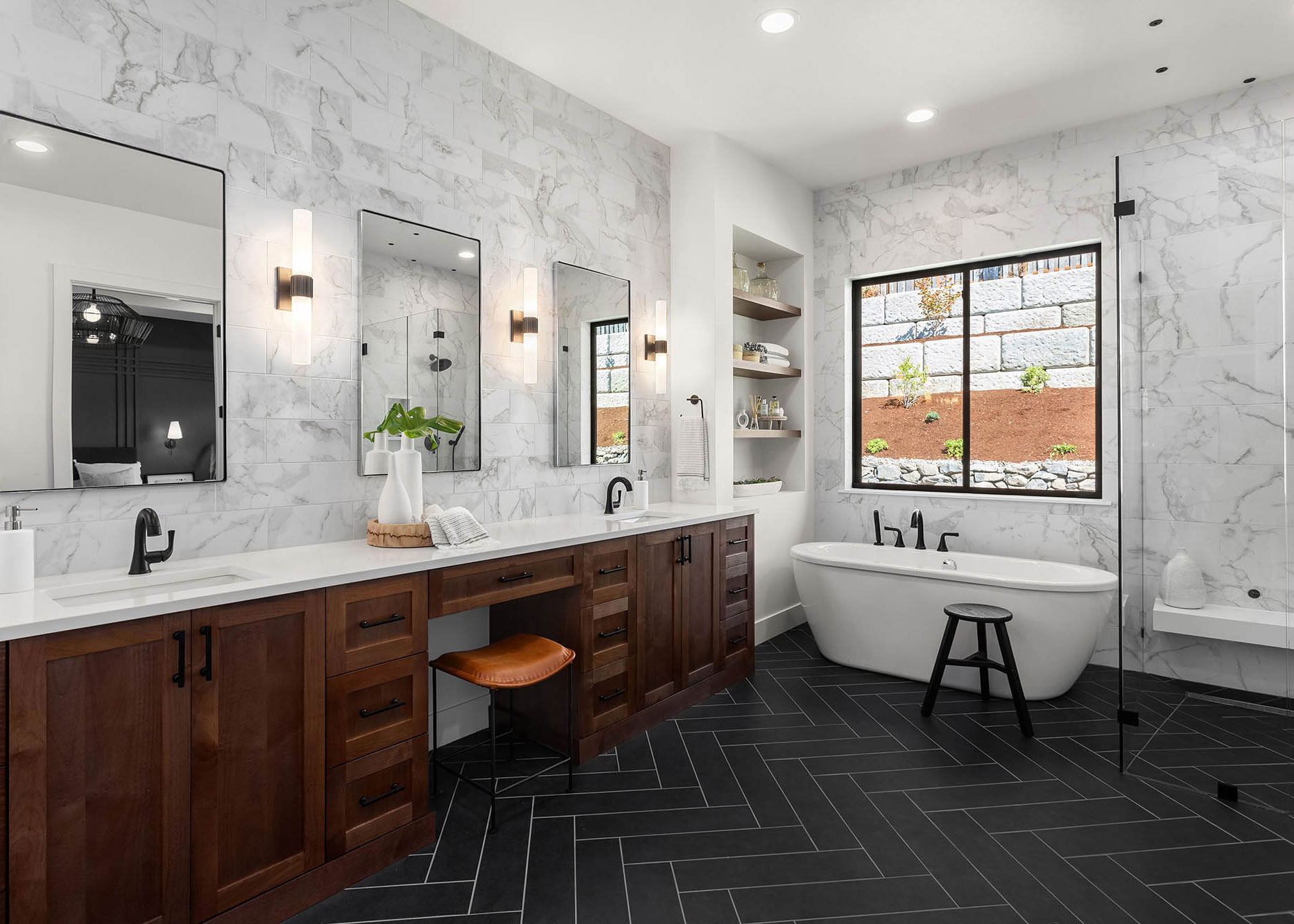 A modern bathroom remodel in Winder, GA features a soaking tub, large window and herringbone pattern floor.